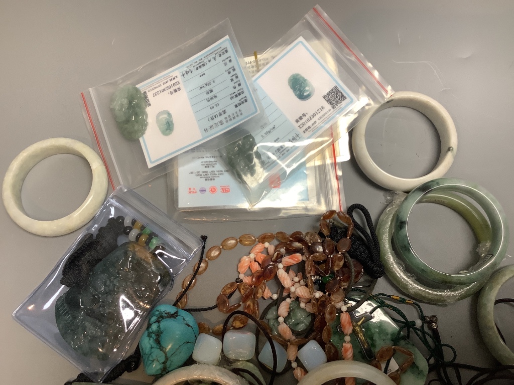 A quantity of Chinese hardstone bangles, carved panels, etc.